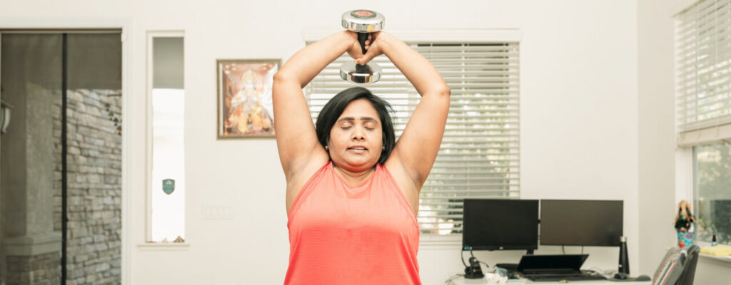 the-role-physical-therapy-in-post-surgical-shoulder-rehab-woman-holding-weight-over-head